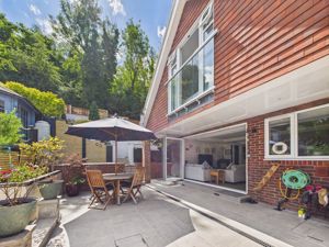 REAR PATIO WITH ALL YEAR ROUND COVERED SEATING AREA- click for photo gallery